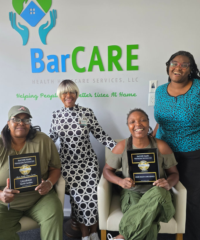 women smiling and holding barcare awards