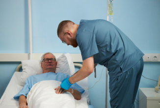 caregiver checking senior on bed