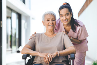 senior and caregiver smiling