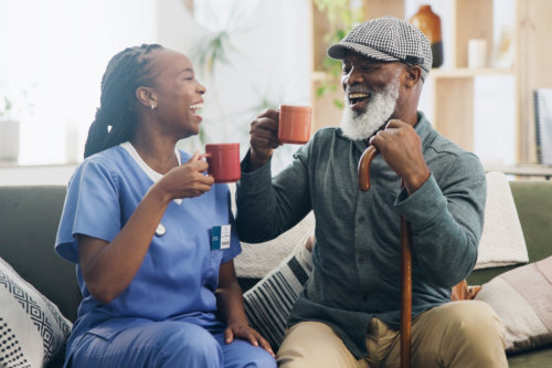 african caregiver talking to a african senior man