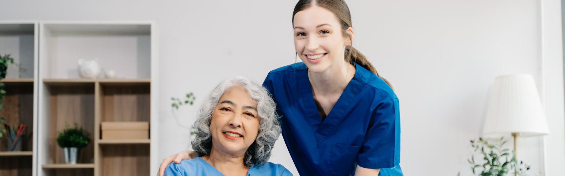 senior woman and caregiver smiling