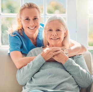 caregiver hugging senior