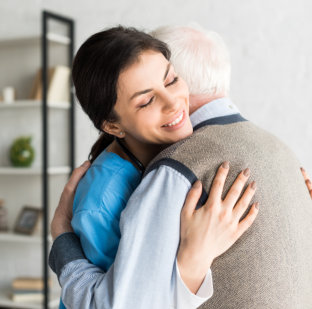 caregiver hugging senior
